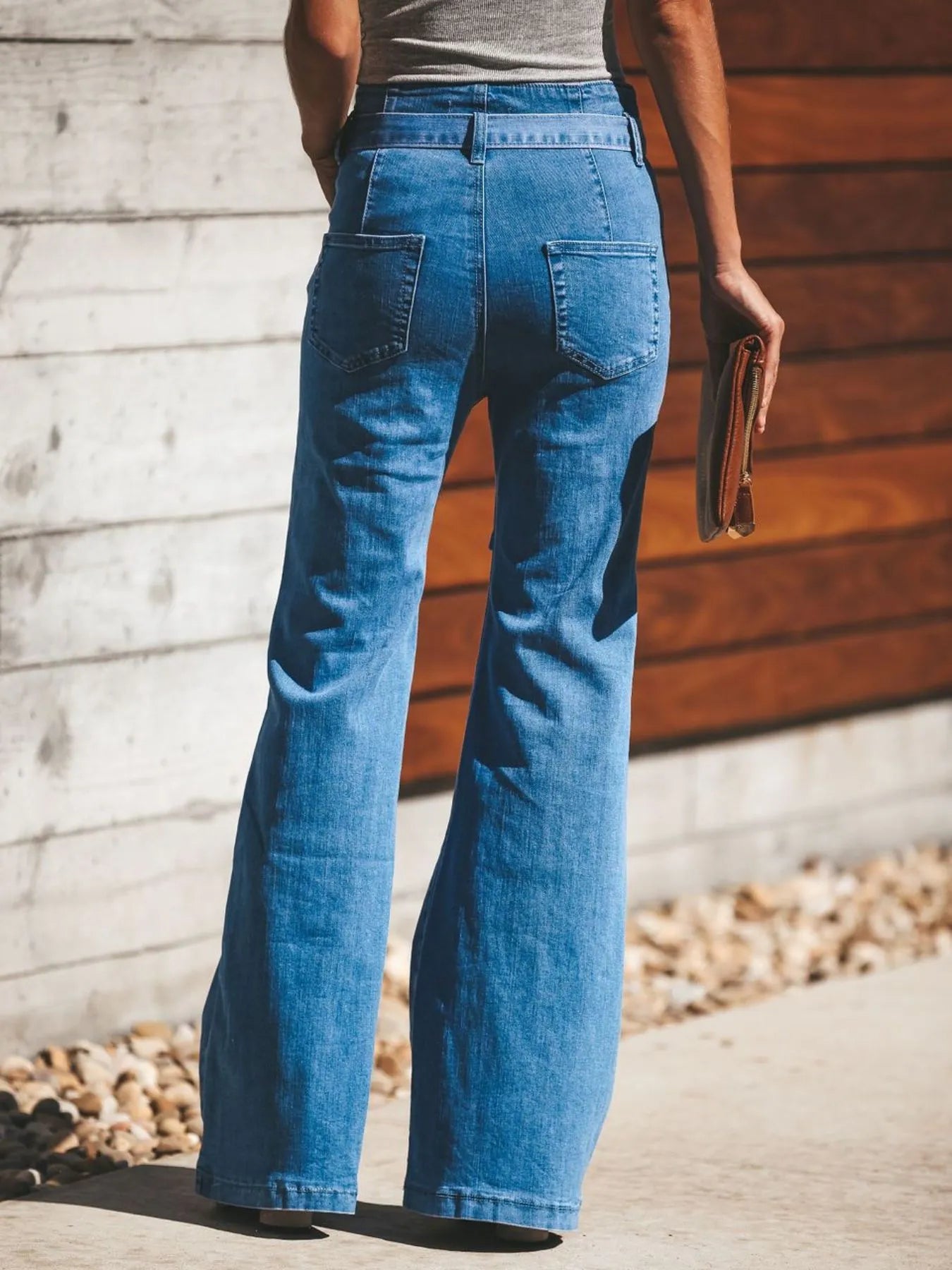Back view of Women's Tie-Front Flare Jeans with patch pockets and flared legs, offering a flattering fit and retro vibe.