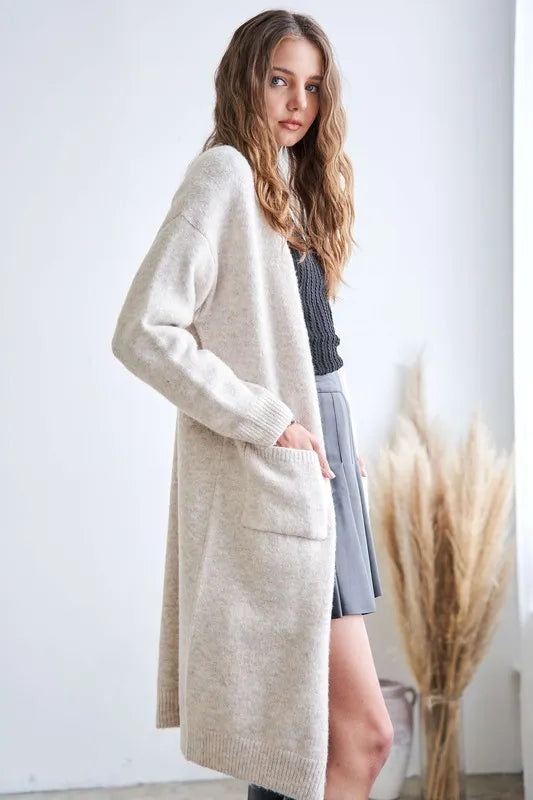 Side view of Adora open cardigan featuring front pockets and soft knit texture, ideal for stylish layering.
