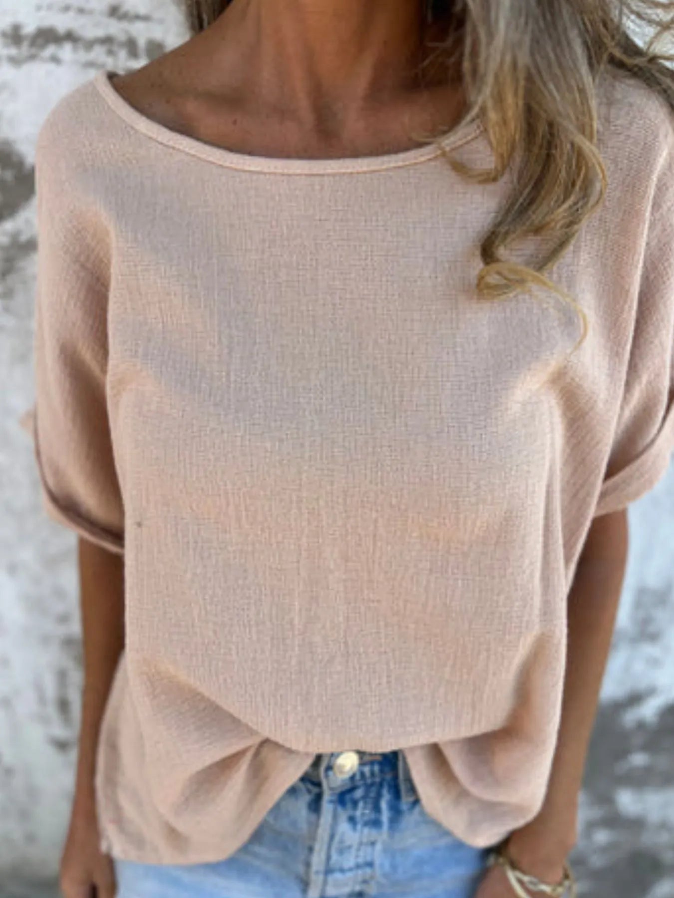 Close-up of beige Women's Oversized Essential Tee showing lightweight texture and wide neckline for a laid-back look.