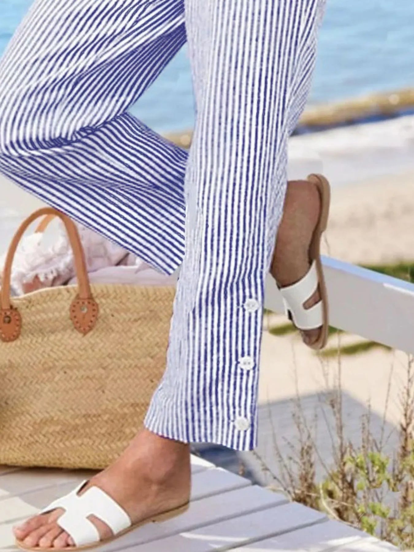 Close-up of button-hem detail on Madison Striped Pants in blue. Features three white buttons for a nautical-inspired finish.