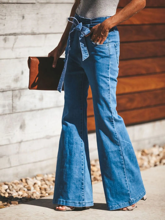 Side view of Women's Tie-Front Flare Jeans featuring a belted waist and flared legs, perfect for casual or dressy outfits.