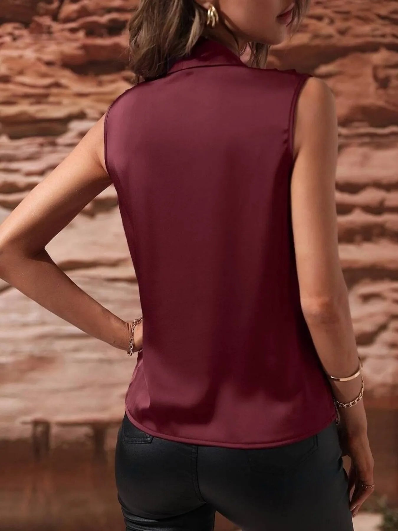 Back view of burgundy Satin Draped Blouse featuring a smooth satin finish and tailored sleeveless cut.