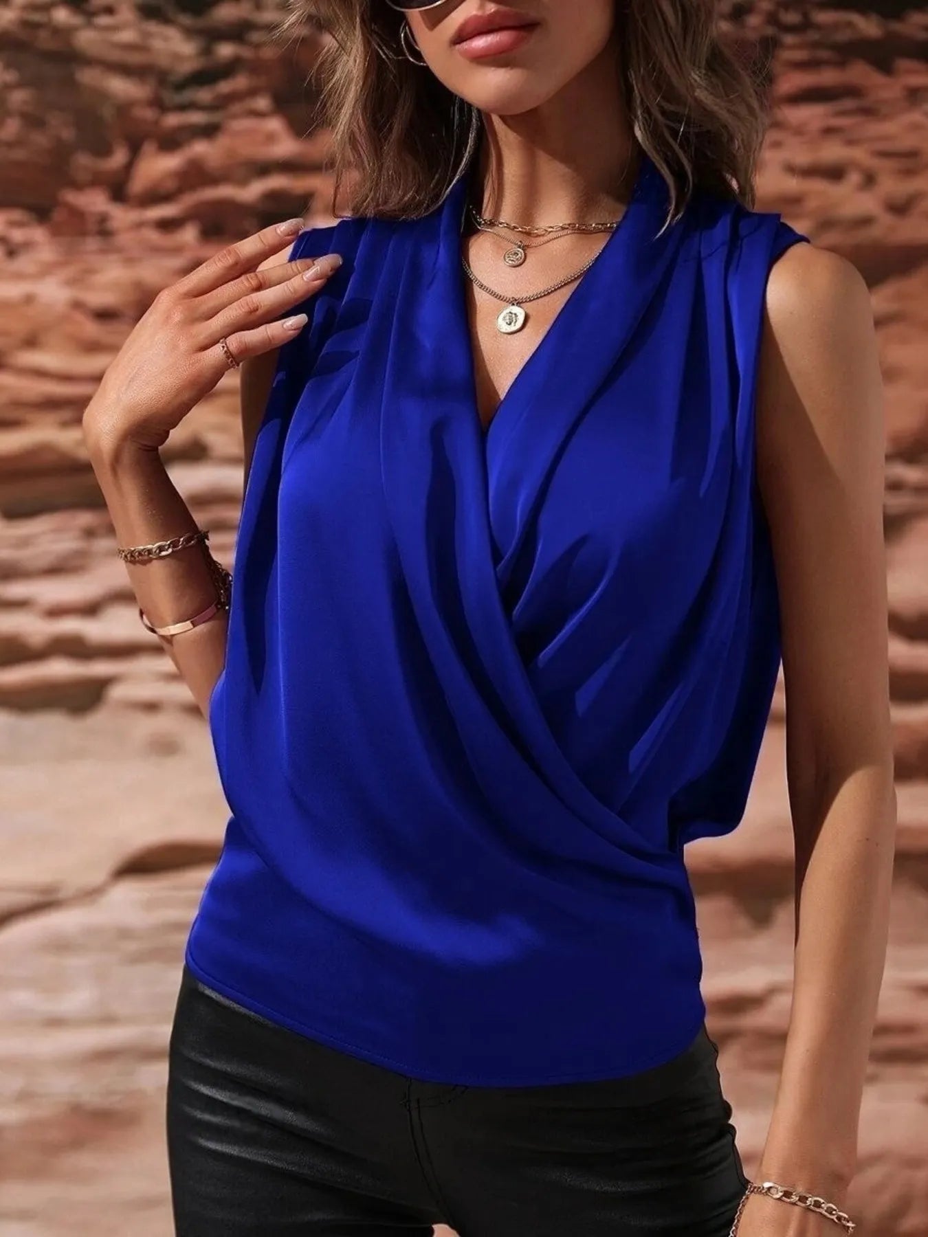 Royal blue Satin Draped Blouse styled with black pants and layered jewelry, perfect for statement day-to-night looks.