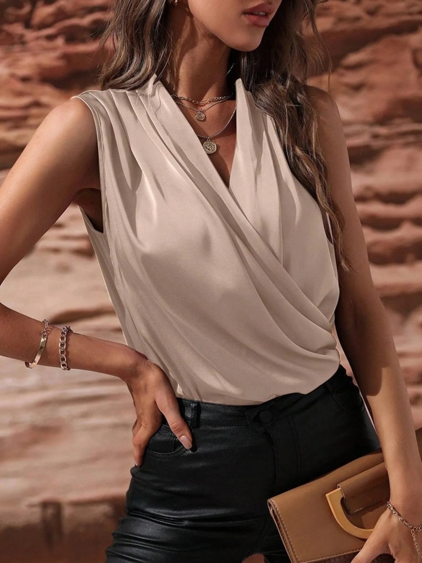 Beige Satin Draped Blouse with wrap front and sleeveless cut, offering a neutral tone for versatile wardrobe pairing.
