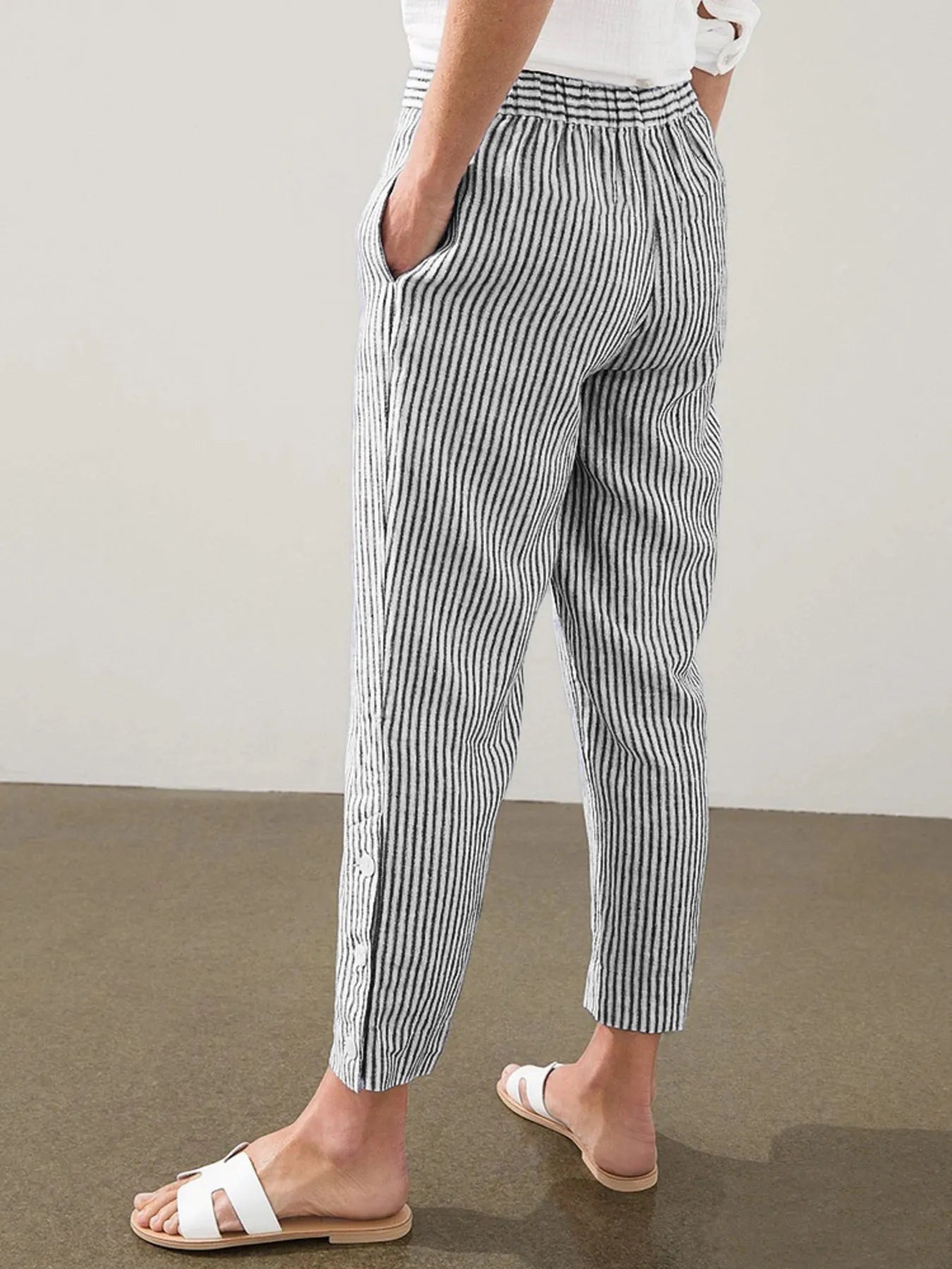 Back view of Madison Striped Button-Hem Pants in black, highlighting elastic waistband and ankle-length cut. Ideal for casual chic looks.