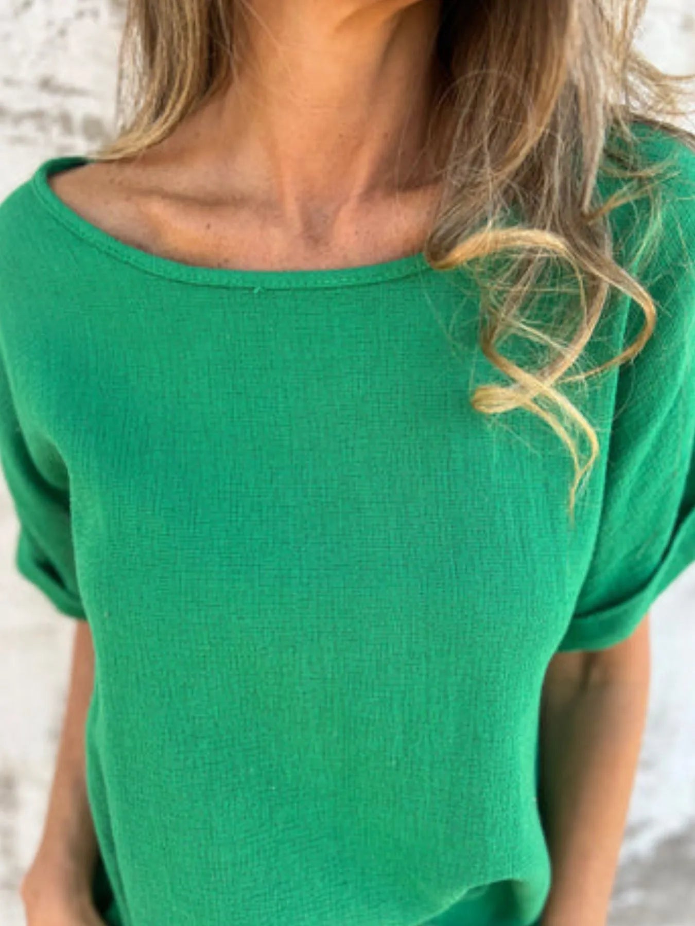 Close-up of green Women's Oversized Essential Tee showing soft fabric texture and wide neckline for a relaxed, breathable fit.