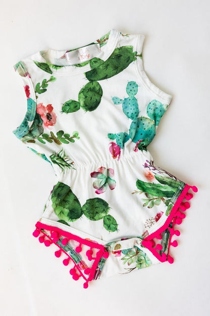 Children's outfit with cactus design and pink pom-pom trim on a white background