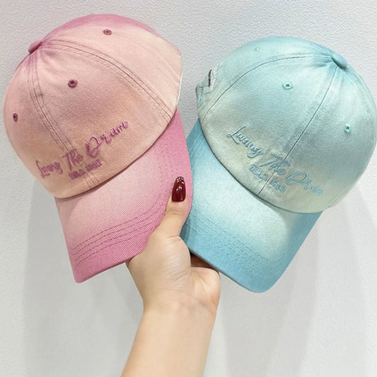 Living the Dream Gradient Denim Baseball Cap in pink and blue, featuring embroidered text and adjustable strap for casual streetwear style.