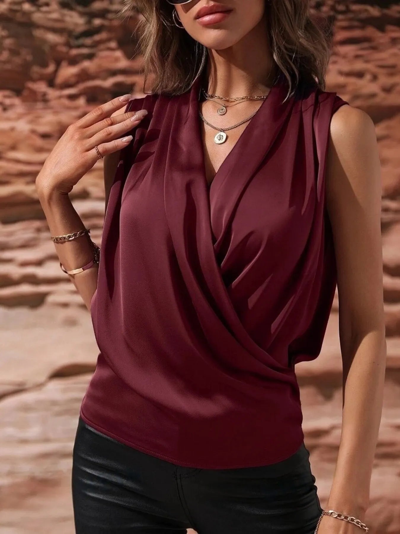 Burgundy Satin Draped Blouse with elegant wrap front and sleeveless design, perfect for fall and winter fashion.