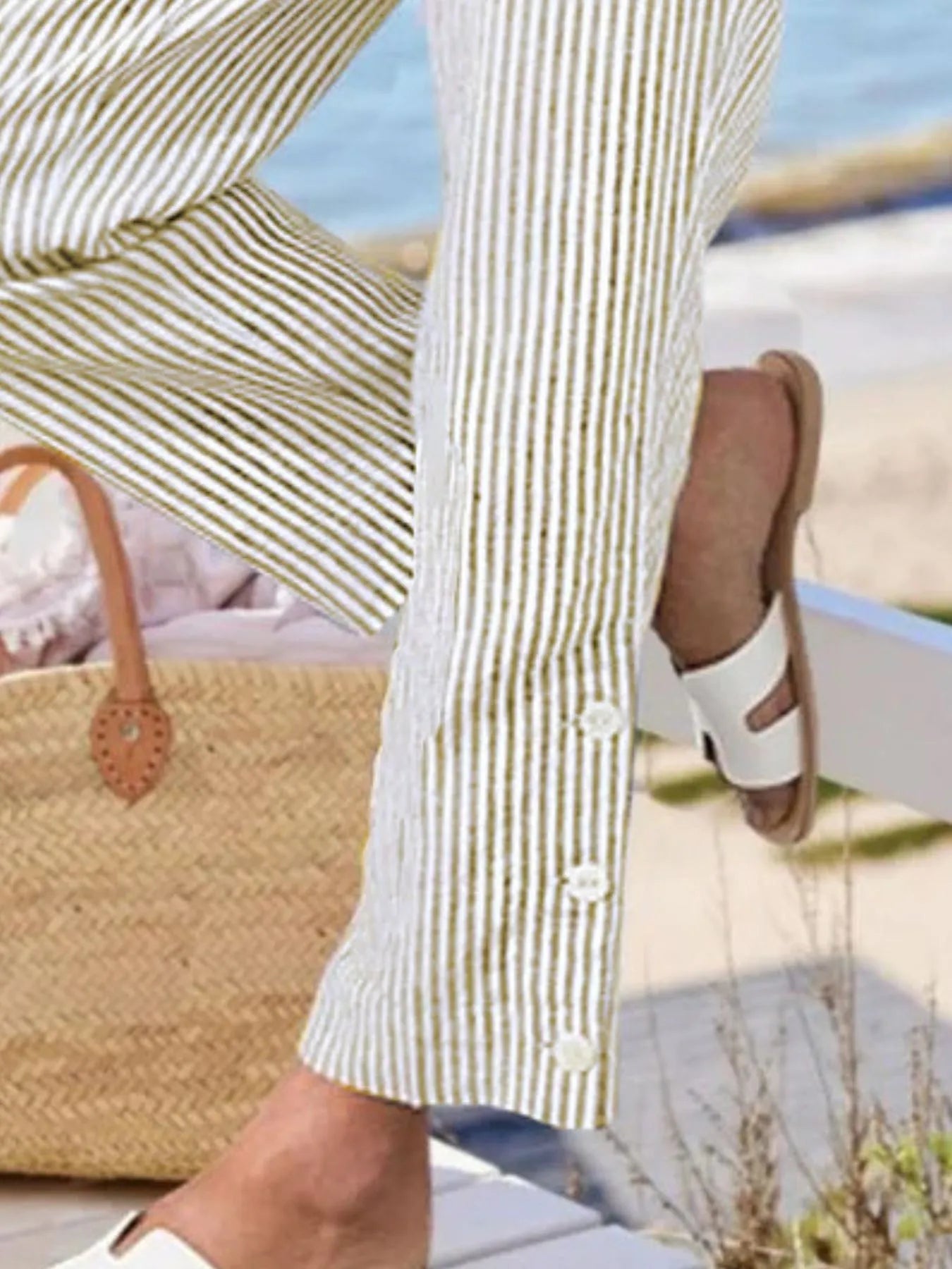 Close-up of button-hem detail on Madison Striped Pants in olive green. Features three white buttons for a coastal-inspired finish.