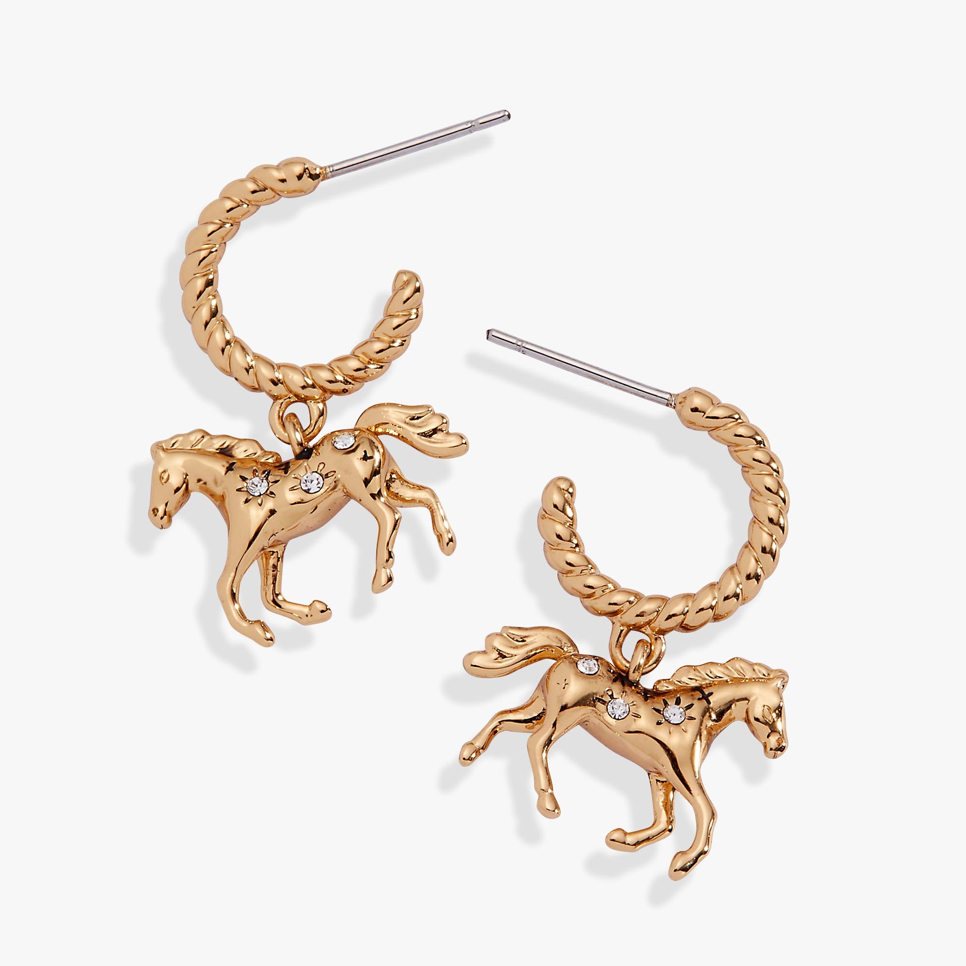 Gold horse-shaped earrings on a white background