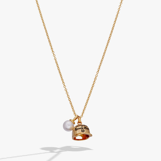 Gold necklace with a bell and pearl pendant on a white background