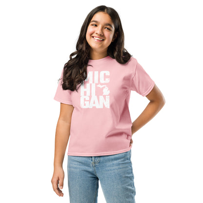 Girl wearing Boldly Michigan youth classic tee in light pink with bold white Michigan graphic. Soft cotton t-shirt perfect for girls' casual outfits.